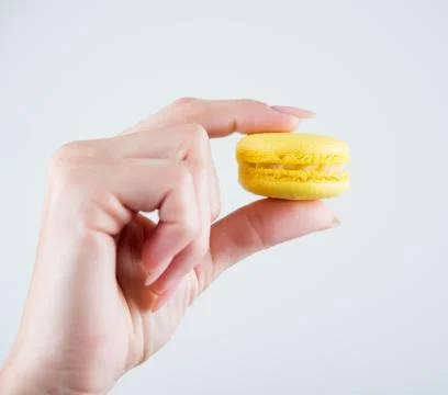 Macarons in hand Stock Photos