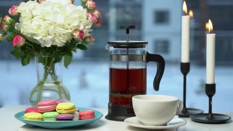 Macarons, hot black tea and flowers Stock Footage 168946286