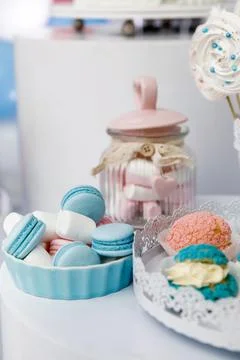 Macarons, marshmallows and cupcakes on the table Stock Photos