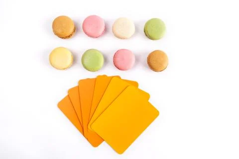 Macarons with orange hues colored samples cards - top view with copy space Stock Photos