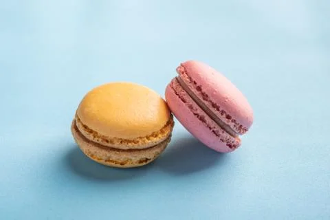 Macarons pattern on blue background. Colorful french desserts. Close up Stock Photos