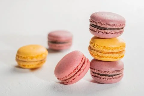 Macarons pattern on white background. Colorful french desserts. Close up Stock Photos
