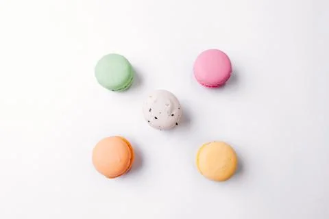 Macarons pattern on white background. Colorful french desserts. Top view. Fla Stock Photos