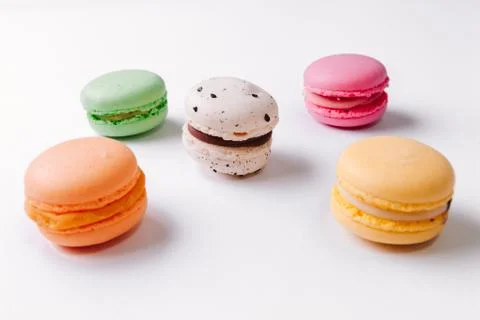Macarons pattern on white background. Colorful french desserts. Top view. Fla Stock Photos