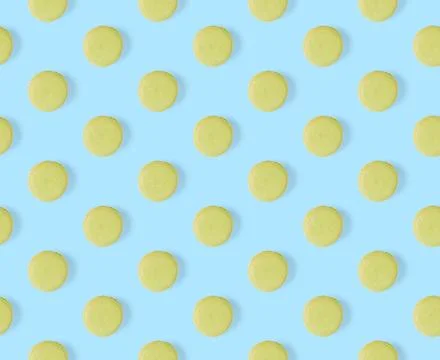 Macarons seamless pattern. macarons isolated on blue background. Stock Photos
