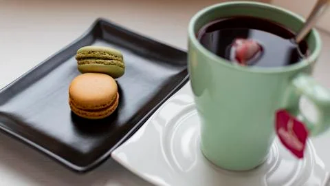 Macarons with tea. Stock Photos
