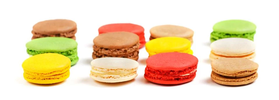Macarons on a white background. Multicolored sweet macarons laid out in rows. Stock Photos