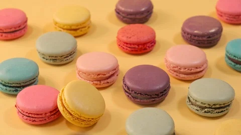 Macarons on yellow background 4K Stock Footage 124794305