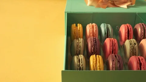 Macarons on yellow background 4K Stock Footage 124794326