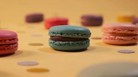 Macarons on yellow background 4K Stock Footage 124794417
