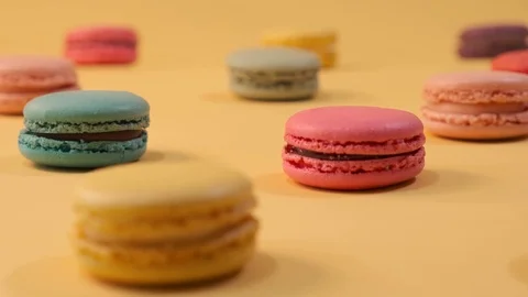 Macarons on yellow background 4K Stock Footage 124794440
