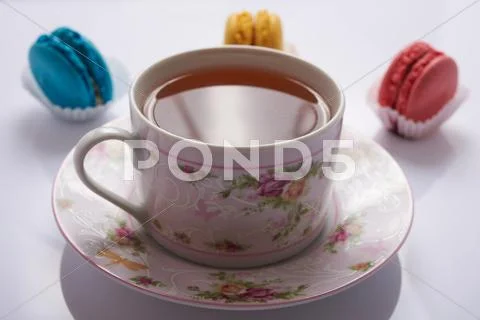 Macaroon and tea on a white background Stock Photos
