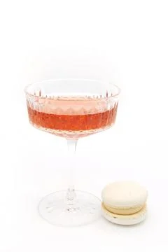 Macaroon and wine on a light background. Stock Photos