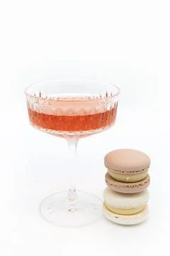 Macaroon and wine on a light background. Stock Photos