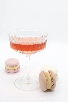Macaroon and wine on a light background. Stock Photos