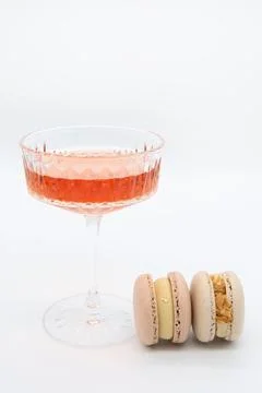 Macaroon and wine on a light background. Stock Photos