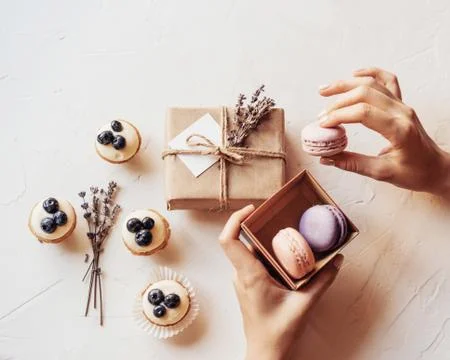 Macaroon cakes box hands Stock Photos