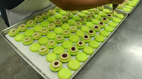 Macaroon cookies being filled by bakery chef dolly shot Video stock 50804080