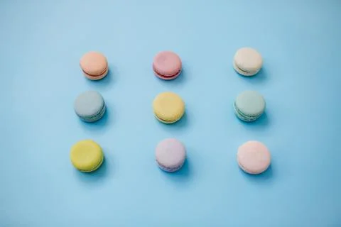 Macaroon or macaron biscuits on pastel blue background. Stock Photos