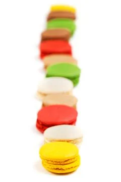 Macaroon row on a white background. Sweet pastries with food dyes. Stock Photos