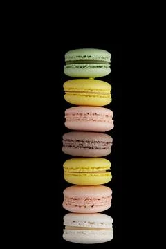 Macaroon. Stack of colorful cake macaron with pastel tones on black backgroun Stock Photos