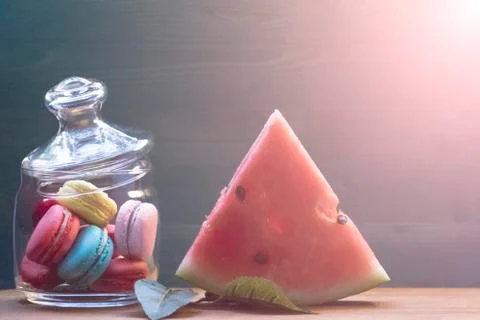 Macaroon, watermelon on a wooden table. The concept of home comfort and warmt Stock-Fotos