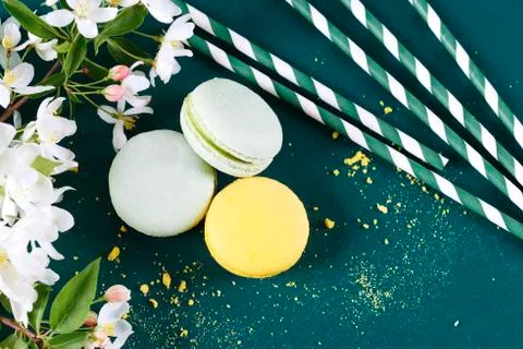 Macaroones between drinking straws and cherry blossom Stock Photos