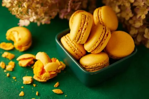 Macaroons are on the green background. Stock Photos