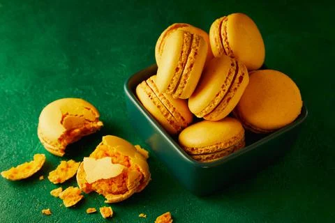 Macaroons are on the green background. Stock Photos