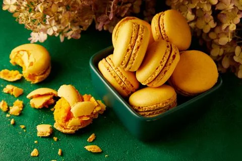 Macaroons are on the green background. Stock Photos