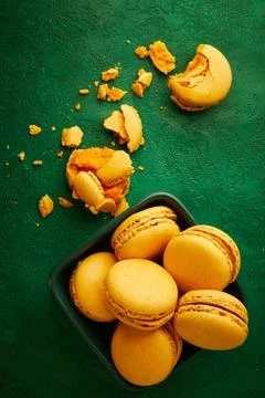 Macaroons are on the green background. Stock Photos