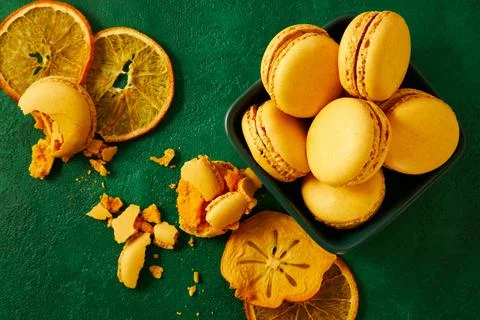 Macaroons are on the green background. Stock Photos