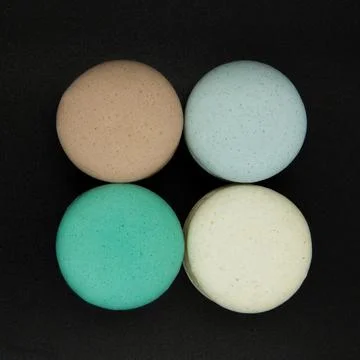 Macaroons on a black background. Stock Photos