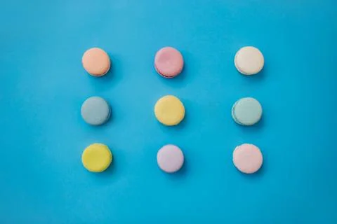 Macaroons on a blue background. Top view. Stock Photos
