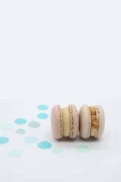 Macaroons with blue dots on a light background. Stock Photos