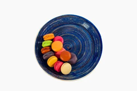 Macaroons on a blue plate Stock Photos