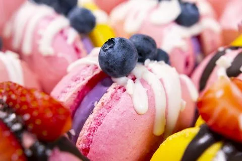Macaroons with blueberry and strawberry. Colourful and Delicious dessert Stock Photos