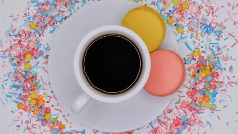 Macaroons with coffee in white cup are rotating on white background. Stock Footage 107413049