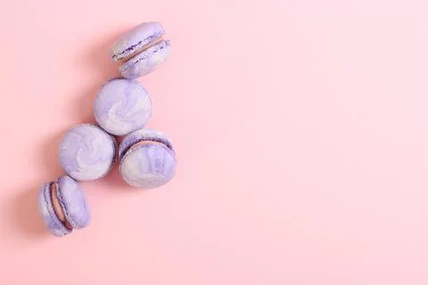 Macaroons on a colored background top view. Stock Photos