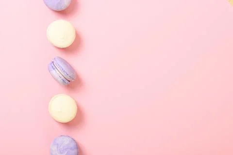 Macaroons on a colored background top view. Stock Photos