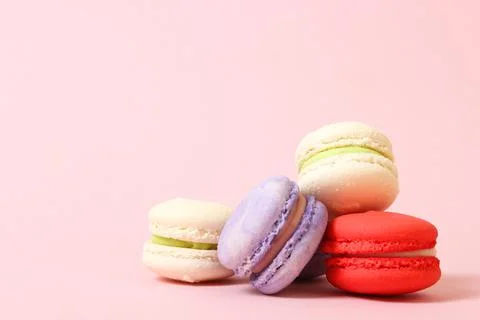 Macaroons on a colored background top view. Stock Photos