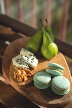 Macaroons, Crushed Walnuts And pears On A Wooden Surface Stock Photos