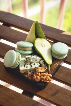 Macaroons, Crushed Walnuts And pears On A Wooden Surface Stockfoto's