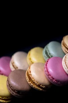 Macaroons of different colors on a black background Foto stock