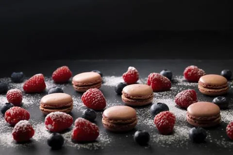 Macaroons of different colors on a black background Foto stock
