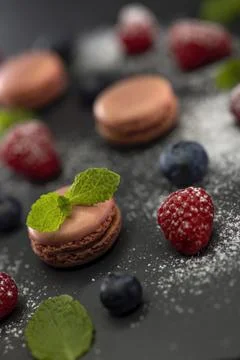 Macaroons of different colors on a black background 스톡 사진