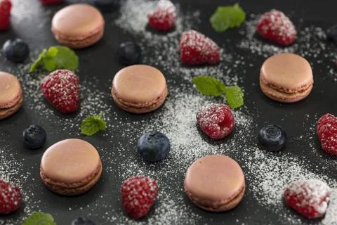 Macaroons of different colors on a black background Foto stock
