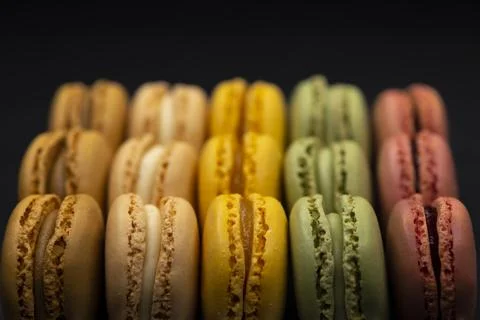 Macaroons of different colors on a black background Stock Photos