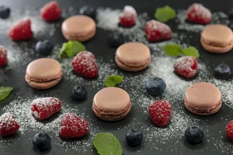Macaroons of different colors on a black background Foto stock