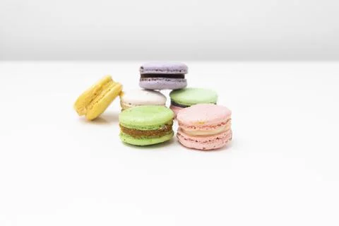 Macaroons in different colours on a withe table Stock Photos